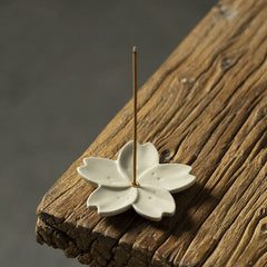 Floral Lotus Ceramic Incense Burner - five-petal cherry blossom with brass ring on aged wood, serene