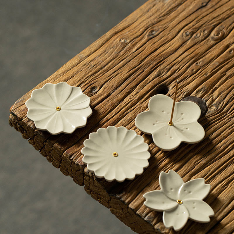 Floral Lotus Ceramic Incense Burner - four-piece set with gold centers on aged wood, serene display