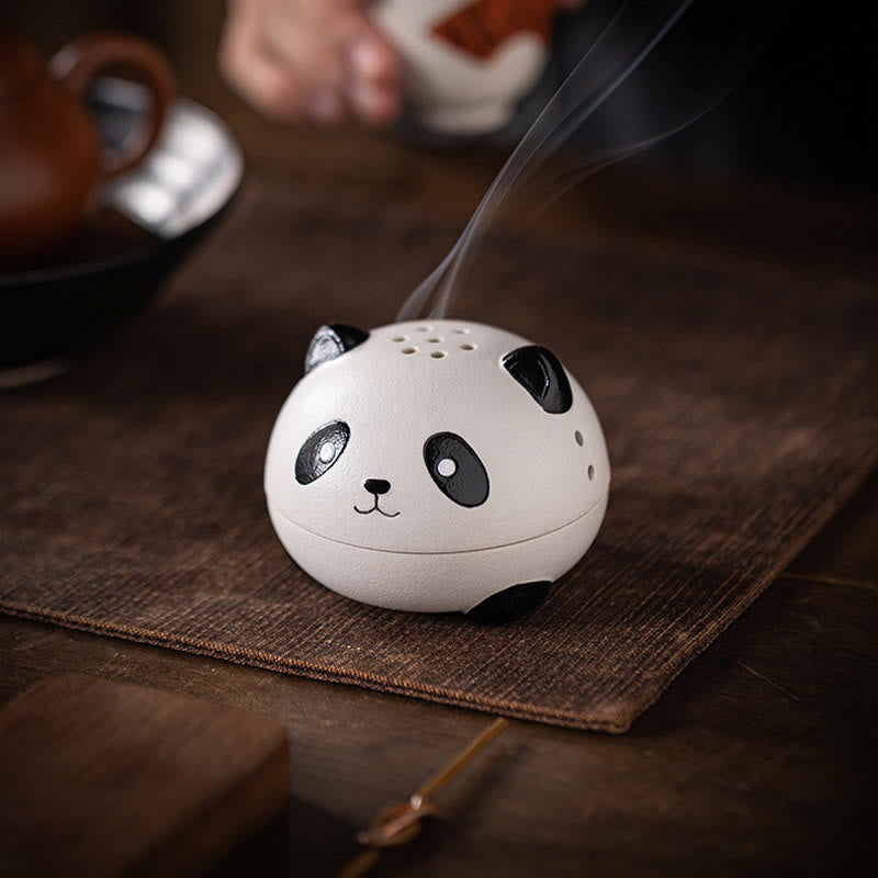Cute Panda Ceramic Incense Burner – Smoking panda on brown mat with teapot and cup in soft background