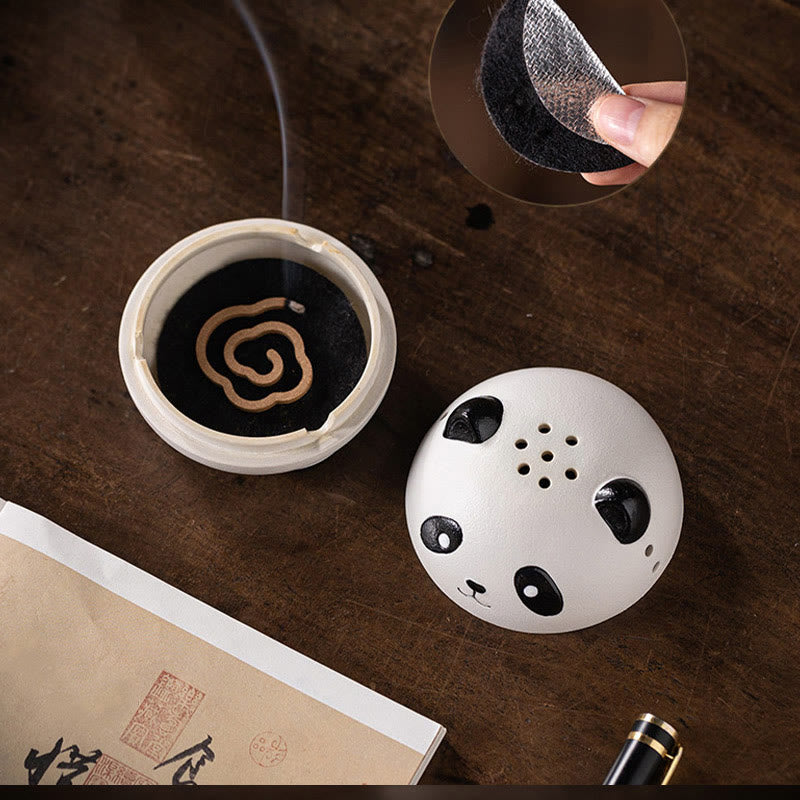 Cute Panda Ceramic Incense Burner – Open base with burning coil incense, felt pad detail inset, book nearby