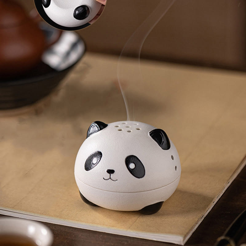 Cute Panda Ceramic Incense Burner – Hand lifting panda lid while smoke drifts, antique book underneath