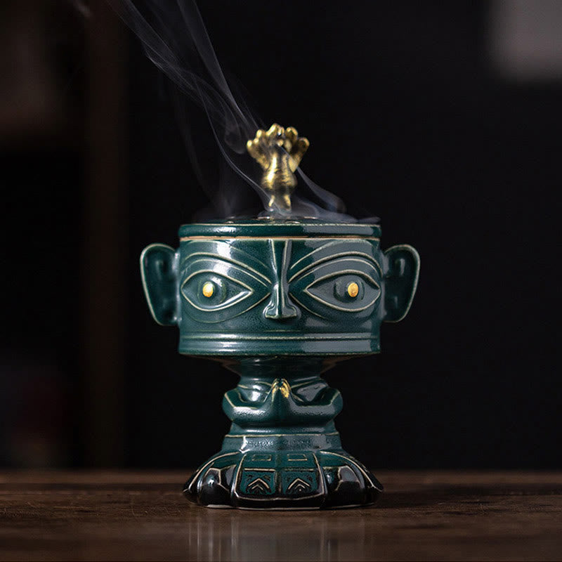 Sanxingdui Ceramic Incense Burner – green glazed mask burner with gold eyes and phoenix lid, wisdom harmony decor