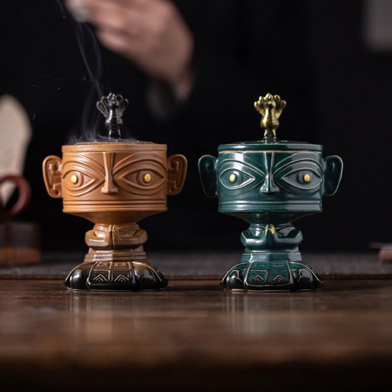 Sanxingdui Ceramic Incense Burner – yellow and green mask burners side by side on wood table, dual color options