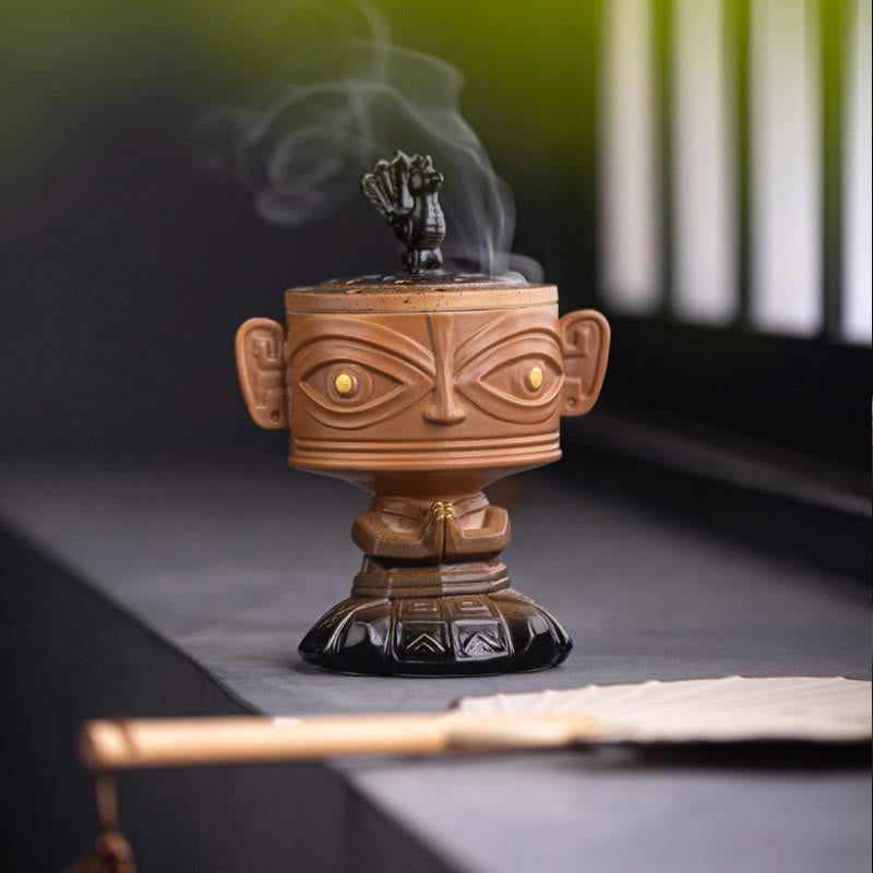Sanxingdui Ceramic Incense Burner – yellow mask burner on black table by bamboo window screen, zen meditation space