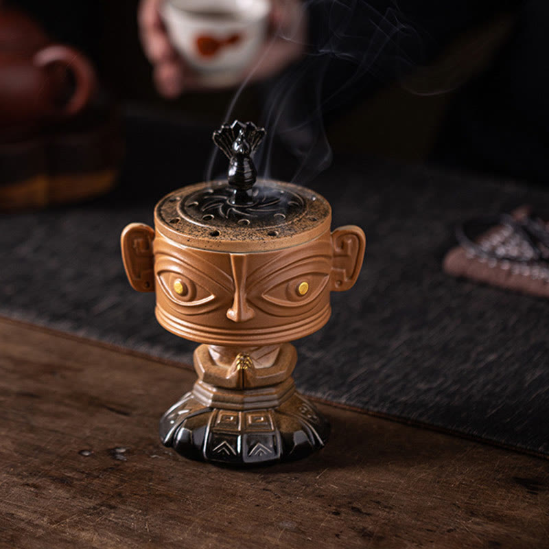 Sanxingdui Ceramic Incense Burner – yellow mask burner on tea table with cup and teapot, mindful living decor