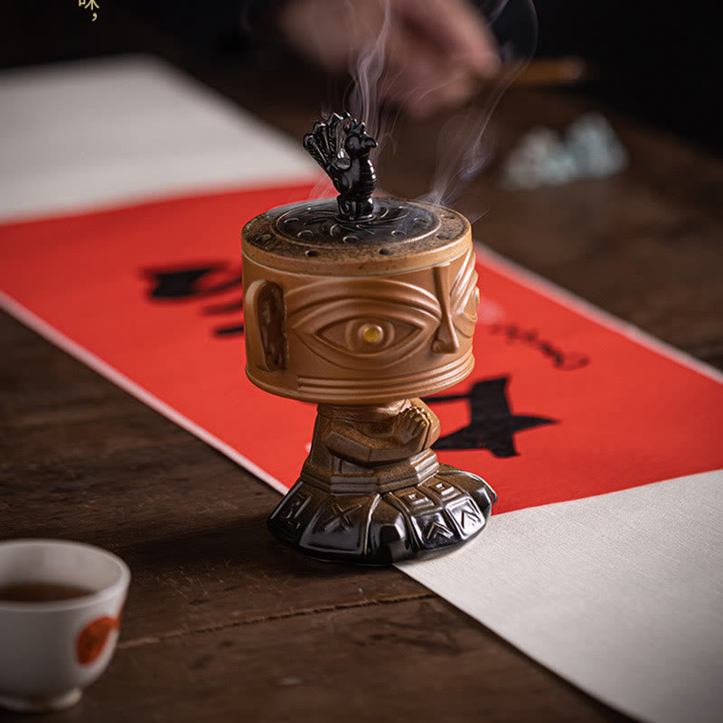 Sanxingdui Ceramic Incense Burner – yellow mask burner on red calligraphy scroll with tea cup, cultural wellness decor
