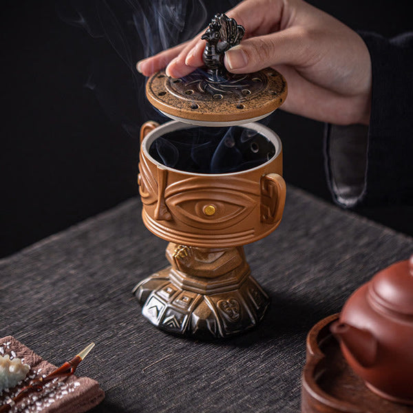 Sanxingdui Ceramic Incense Burner – hand lifting phoenix lid revealing hollow interior, functional design detail