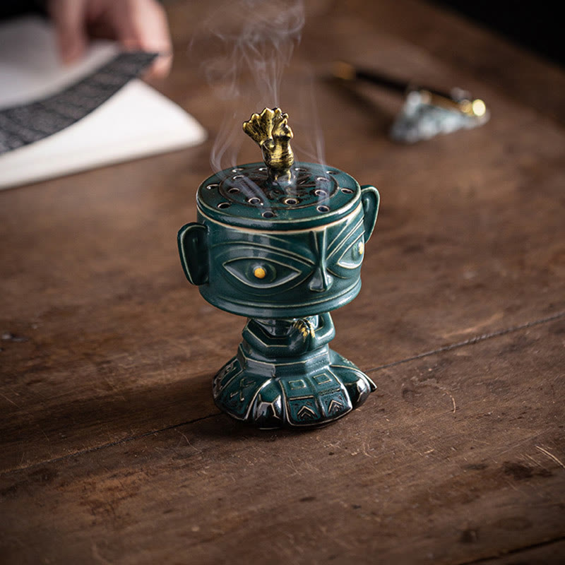 Sanxingdui Ceramic Incense Burner – green mask burner on rustic wood desk with calligraphy brush, scholarly zen space