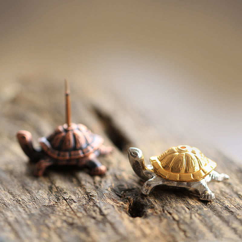 Alloy Turtle Snail Incense Burner – both color variants on natural wood, warm contemplative scene