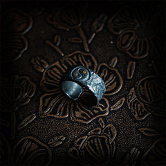 999 Sterling Silver Yin Yang Ring - overhead angle on leather showing blackened silver texture and gold dot detail, balanc...