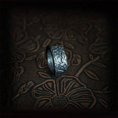 999 Sterling Silver Yin Yang Ring - side view standing showing volcanic hammered texture on dark gunmetal band, artisan ring