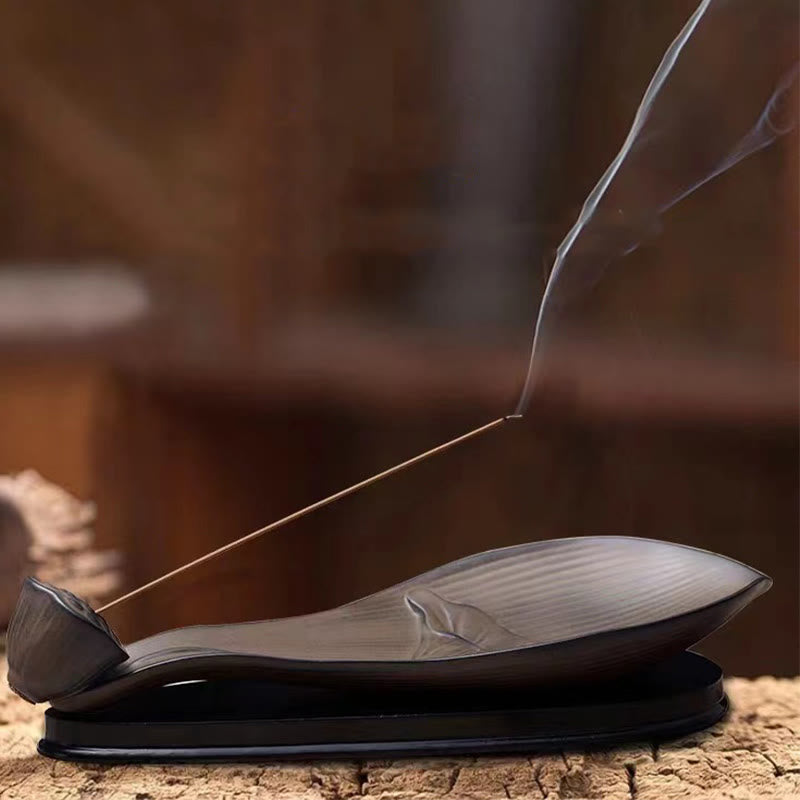 Brown Ceramic Lotus Pod Zen Incense Burner - low angle on dark base with curling smoke, tranquil