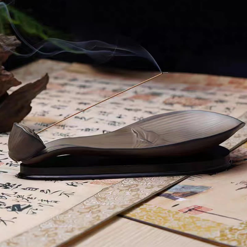 Brown Ceramic Lotus Pod Zen Incense Burner - smoke rising on calligraphy against black, contemplative
