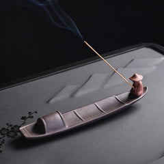 Fisherman Boat Purple Clay Incense Burner – mirrored side view on floral tea tray, tranquil home decor