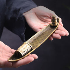 Fisherman Boat Alloy Incense Burner – held in hands showing size and bronze texture, artisan craft