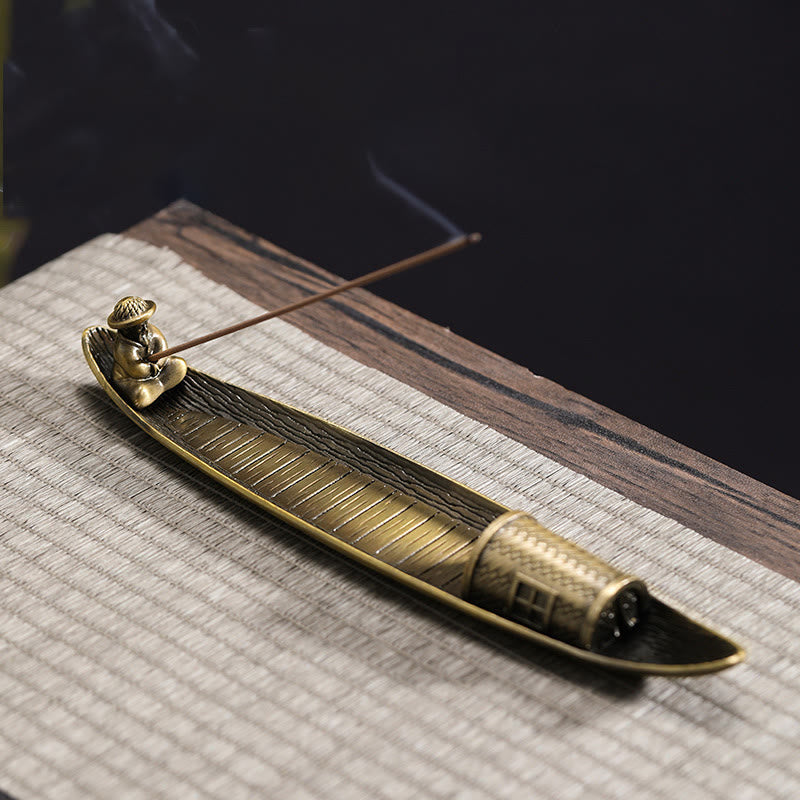 Fisherman Boat Alloy Incense Burner – resting on woven mat with incense smoke, calming ritual
