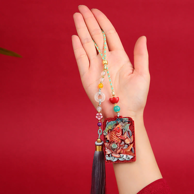 Cinnabar Koi Fish Car Hanging – pendant held in hand on red, koi fish relief, beads, tassel, scale reference