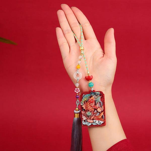 Cinnabar Koi Fish Car Hanging – pendant held in hand on red, koi fish relief, beads, tassel, scale reference