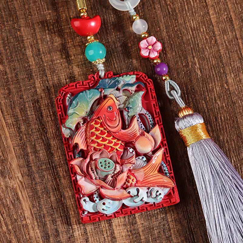 Cinnabar Koi Fish Car Hanging – carved koi lotus pendant on wood surface, flat lay, cinnabar red, tassel