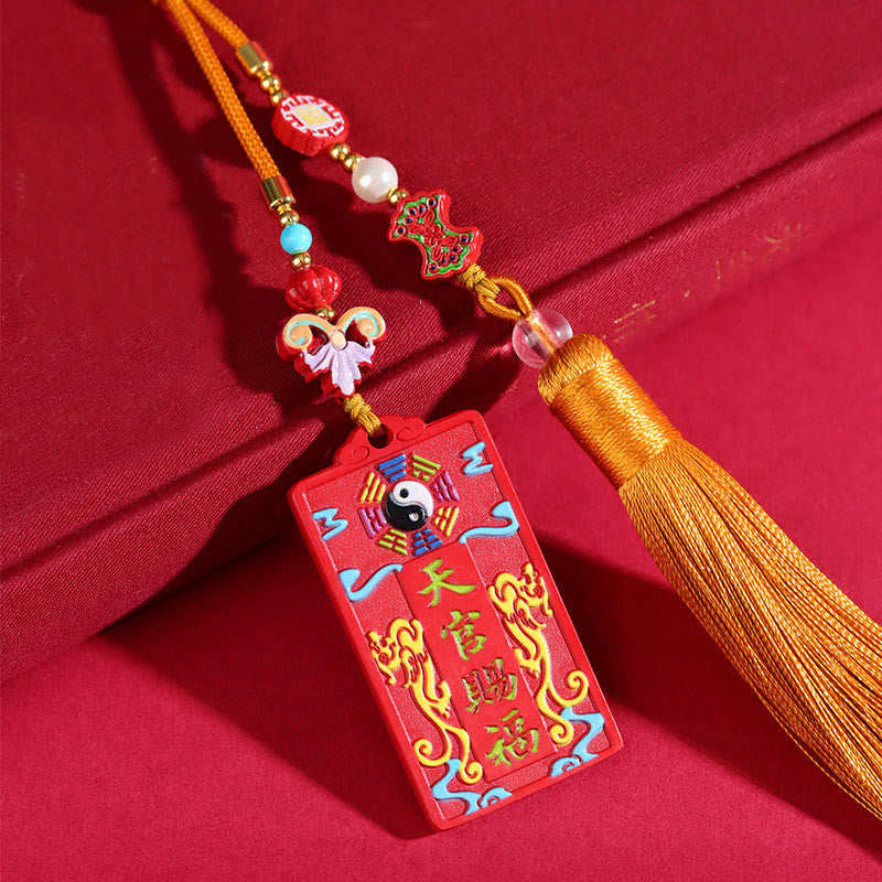 Natural Cinnabar Bagua Yin Yang Fu Hanging - three-quarter view on red fabric showing bagua pendant with beaded tassel, fe... Main image
