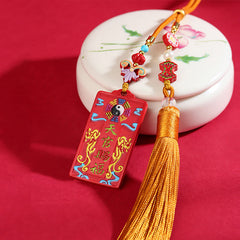 Natural Cinnabar Bagua Yin Yang Fu Hanging - angled view with lotus ceramic prop showing tassel and beadwork, cinnabar car...
