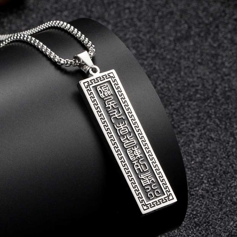 Nine-Word Mantra Bagua Yin Yang Titanium Steel Pendant - Silver pendant on dark stand, seal script, men spiritual jewelry