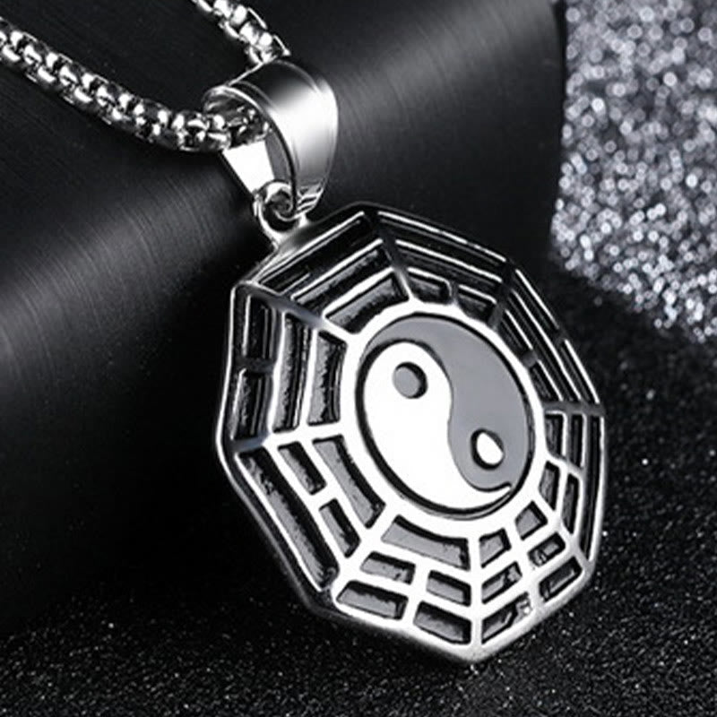 Titanium Steel Bagua Yin Yang Necklace - Silver Yin Yang Bagua pendant three-quarter angle on dark fabric