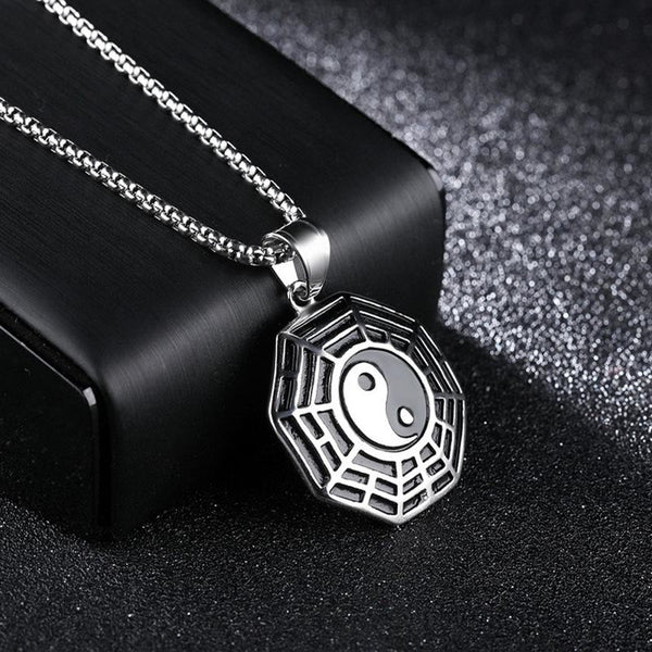 Titanium Steel Bagua Yin Yang Necklace - Silver Bagua pendant on dark velvet with display prop, close-up shot