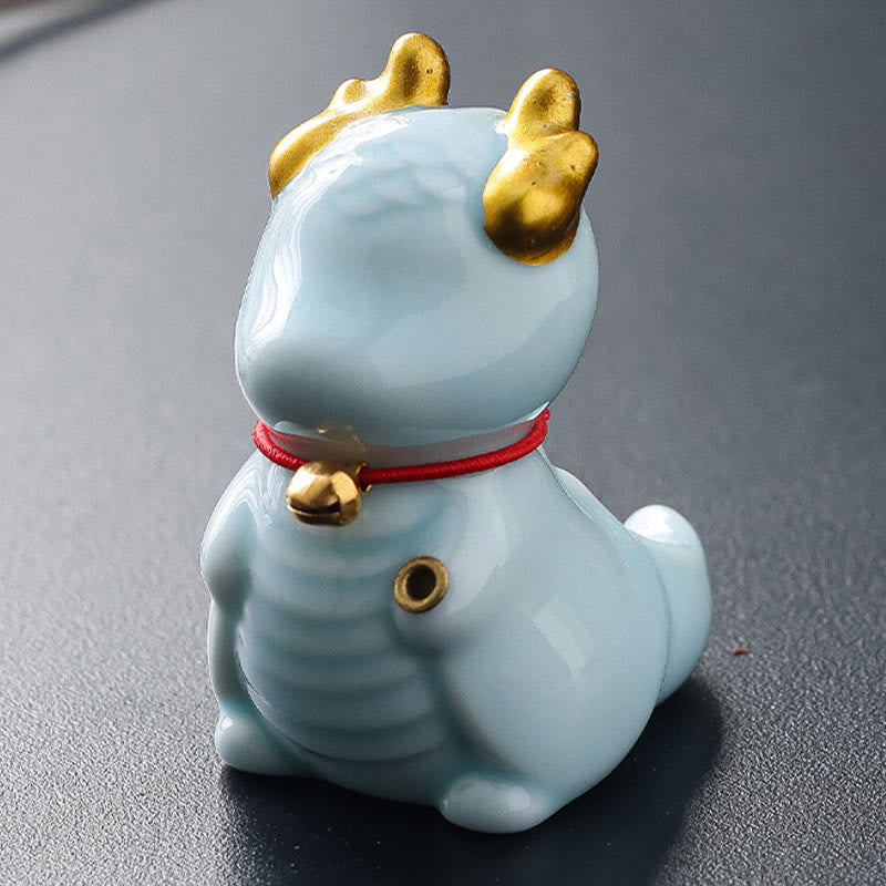 Ceramic Dragon Bell Incense Burner – rear view with indigo floral fabric mat, fishing pose, Playful