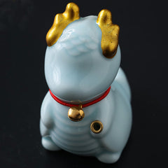 Ceramic Dragon Bell Incense Burner – three-quarter side on dark leather surface, faceless design, Harmony