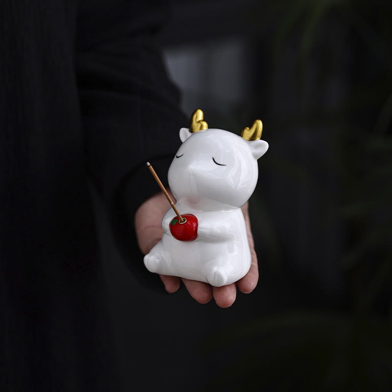 Deer Ceramic Incense Burner – White deer held in hand, gold antlers and red apple, incense burning, ceramic figurine