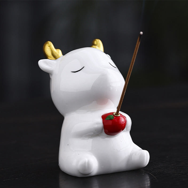 Deer Ceramic Incense Burner – Side view of white deer holding red apple with incense, gold antlers, glazed ceramic