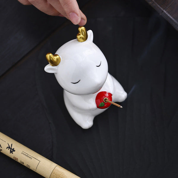 Deer Ceramic Incense Burner – White deer with finger touching gold antler, incense smoke, ceramic incense accessory