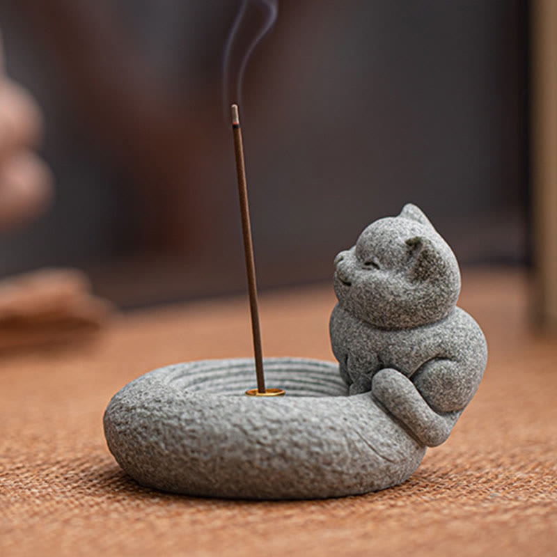 Lazy Cat Sandstone Incense Burner – cat beside lit incense on tan linen, low angle view, natural stone texture detail