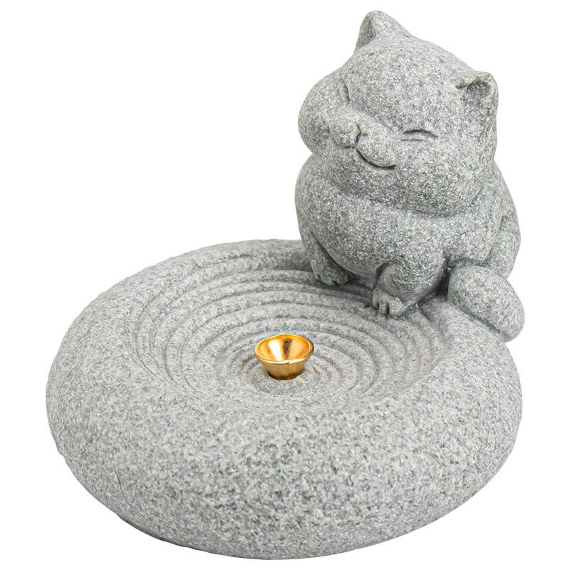 Lazy Cat Sandstone Incense Burner – cat on pure white background, zen ripple base with gold incense holder, e-commerce studio