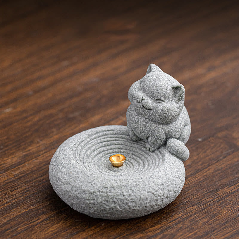 Lazy Cat Sandstone Incense Burner – cat with paw to face on dark wood, ripple-patterned base, elevated angle, zen decor