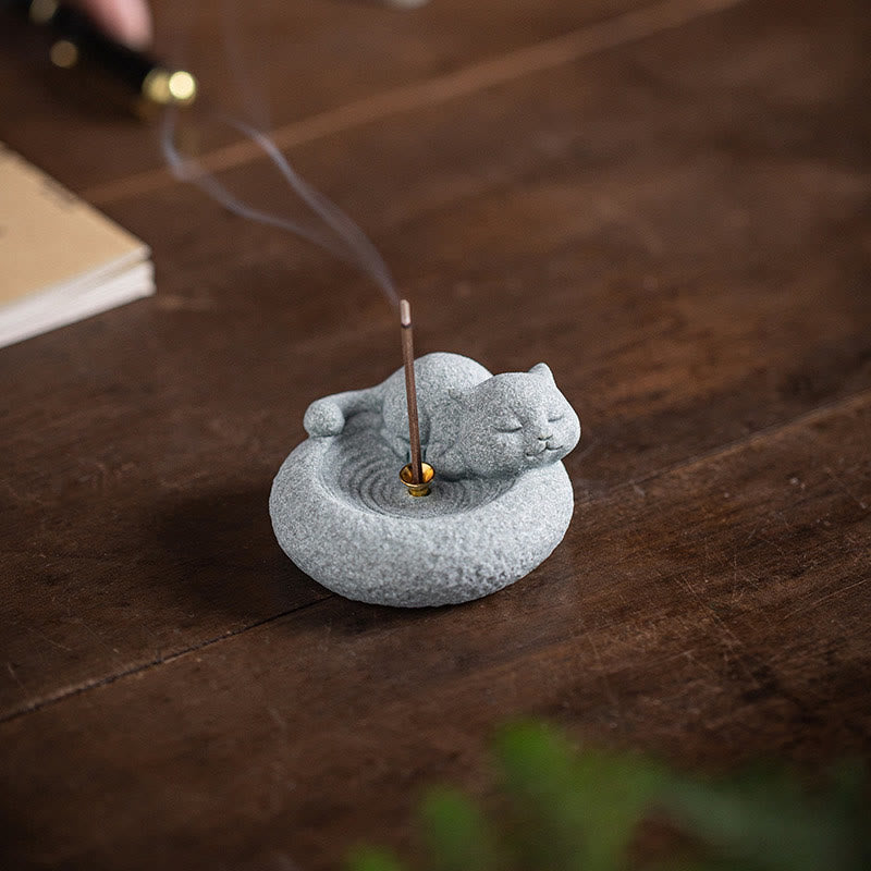 Lazy Cat Sandstone Incense Burner – sleeping cat on rustic wood, black backdrop, incense smoke trail, moody zen shot
