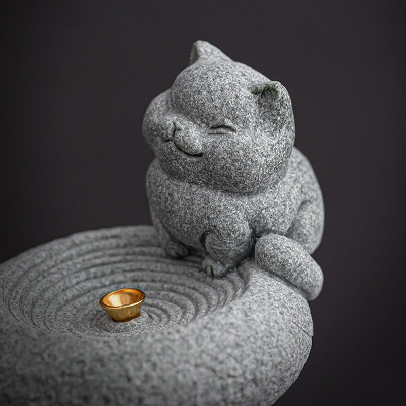 Lazy Cat Sandstone Incense Burner – cat on dark gray backdrop, incense cup in focus, concentric ring base, studio shot