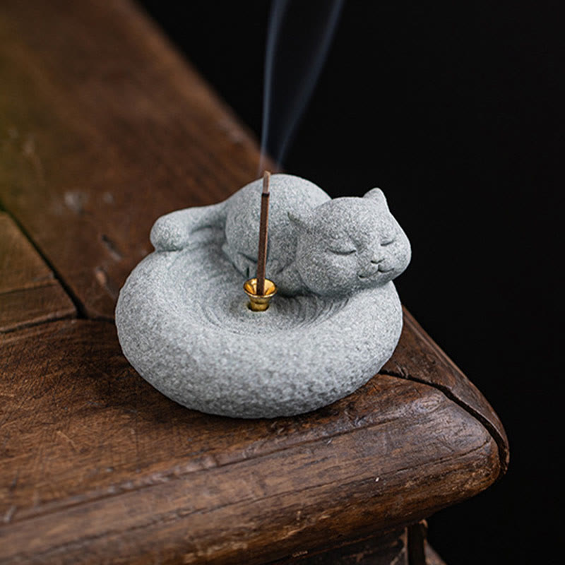 Lazy Cat Sandstone Incense Burner – cat face close-up on dark wood, gold incense accent, shallow depth of field zen shot