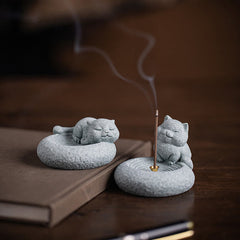 Lazy Cat Sandstone Incense Burner – two cat figurines, sleeping and seated, on dark wood with book, incense burning, zen d...