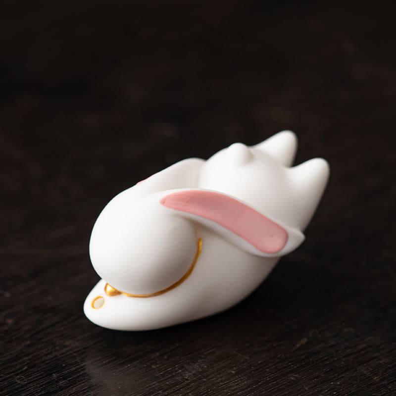 Flying Rabbit Ceramic Incense Burner – white rabbit held in hand showing pink ear, ceramic incense burner