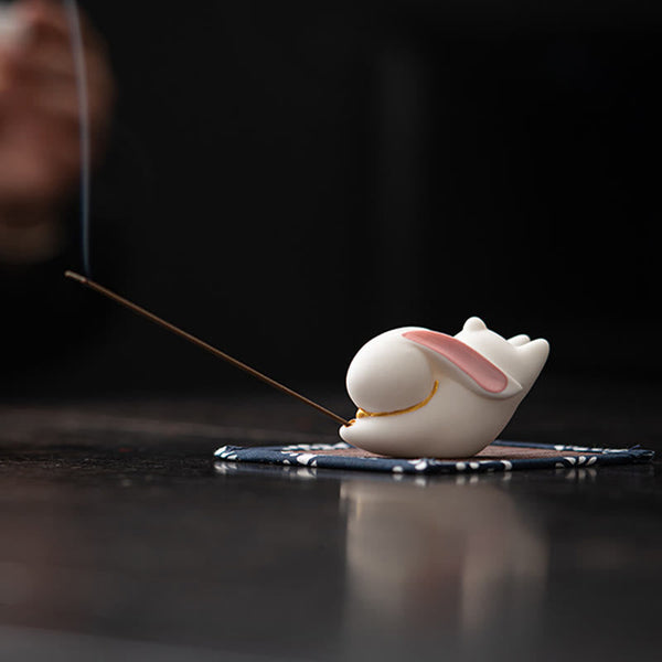 Flying Rabbit Ceramic Incense Burner – white rabbit with smoke on dark surface, ceramic incense burner