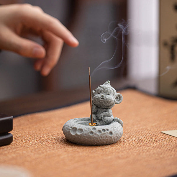 Chinese Zodiac Sandstone Incense Burner – cat lying on back with incense, dark wood, paw print base, playful zen decor