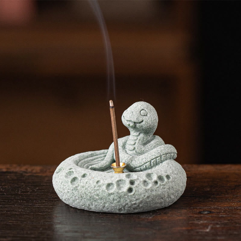 Chinese Zodiac Sandstone Incense Burner – snake in meditation pose with incense, dark wood background, zen stone craft