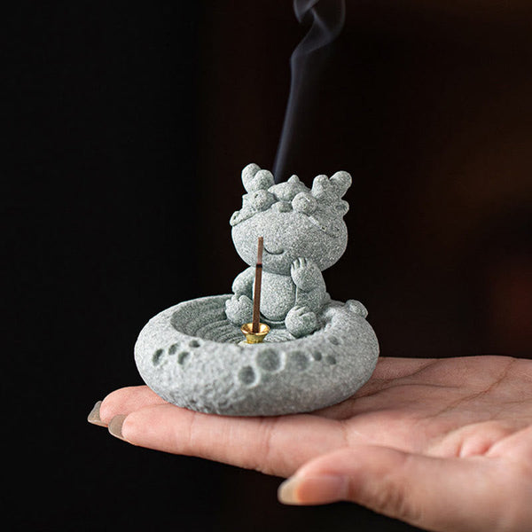 Chinese Zodiac Sandstone Incense Burner – dragon in palm with smoke, calligraphy background, traditional East Asian aesthetic