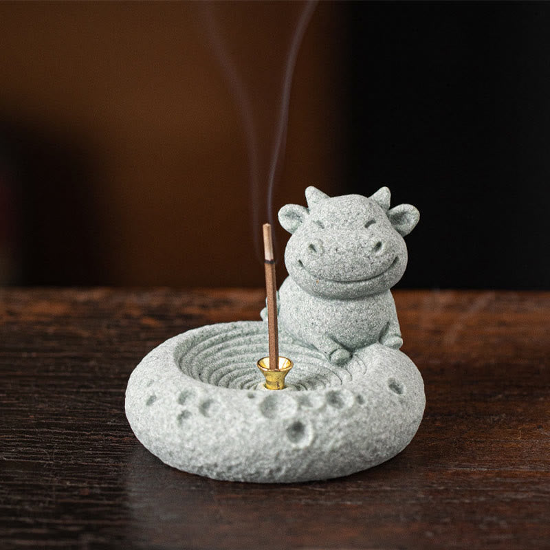 Chinese Zodiac Sandstone Incense Burner – smiling ox with burning incense on dark wood, moody bokeh, zodiac stone decor