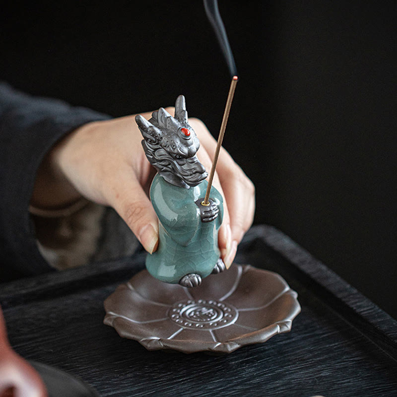 Ceramic Dragon King Incense Burner – held in hand with lotus base, black dramatic lighting, Artisan