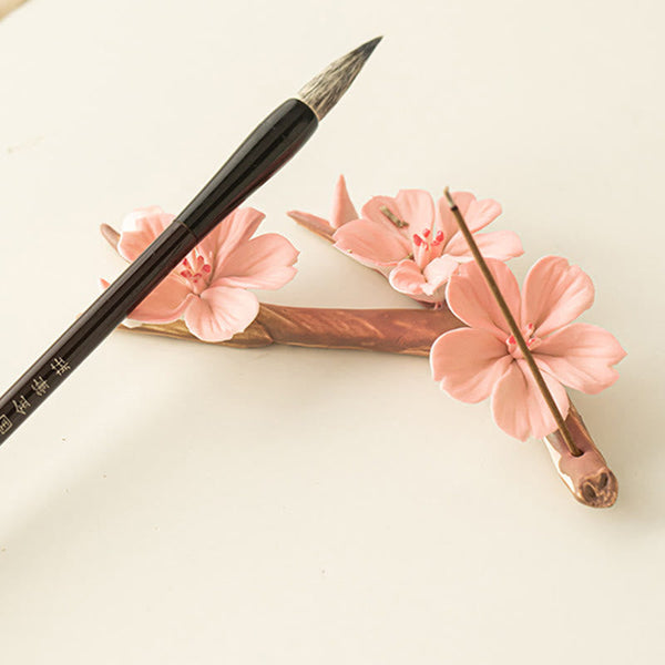 Plum Blossom Incense Burner – Pink sakura ceramic branch with incense and calligraphy brush, zen decor
