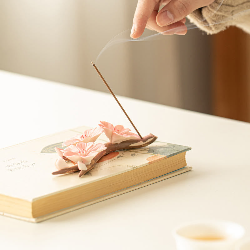 Plum Blossom Incense Burner – Burning incense with rising smoke on pink sakura ceramic branch, meditation