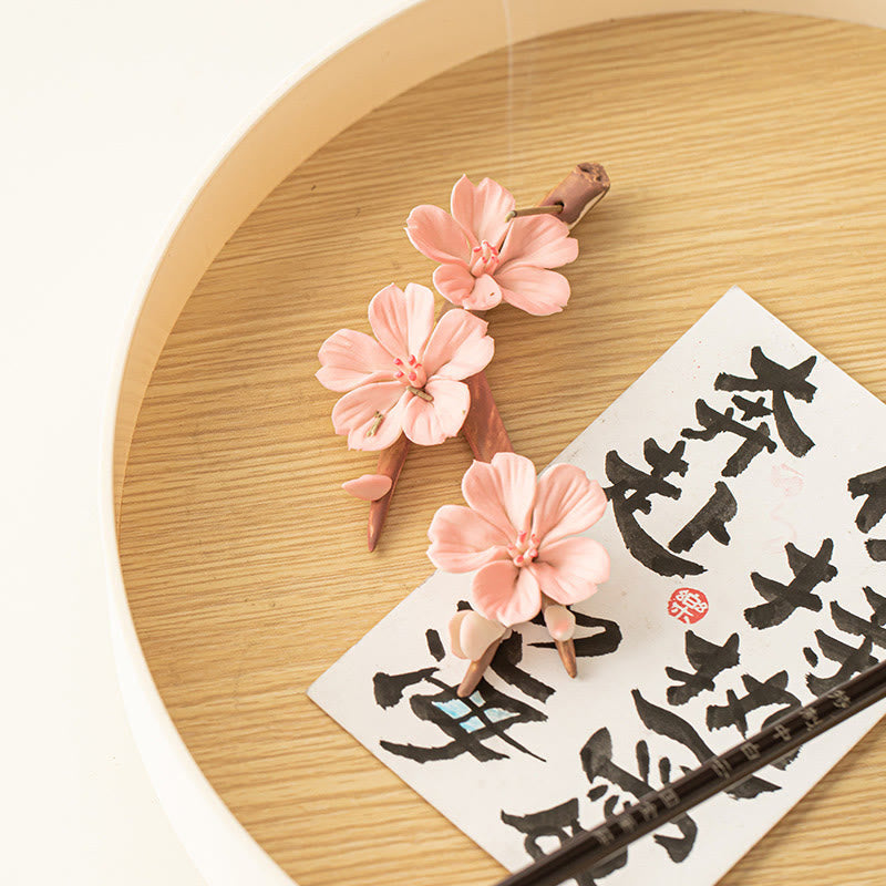 Plum Blossom Incense Burner – Pink ceramic sakura on bamboo tray with calligraphy card, zen meditation